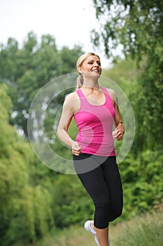 Athletic young woman running outdoors