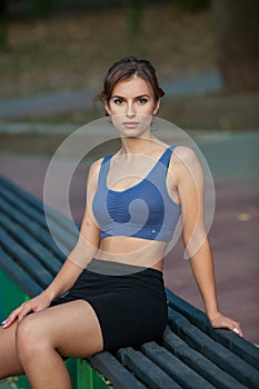 Athletic young woman in sportswear jogging in the park. Sport fitness model caucasian ethnicity training outdoor.