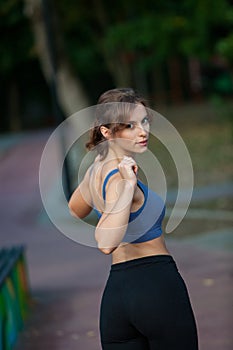 Athletic young woman in sportswear jogging in the park. Sport fitness model caucasian ethnicity training outdoor.