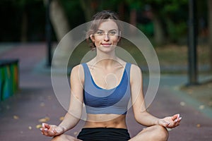 Athletic young woman in sportswear jogging in the park. Sport fitness model caucasian ethnicity training outdoor.