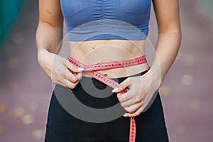 Athletic young woman in sportswear jogging in the park. Sport fitness model caucasian ethnicity training outdoor.