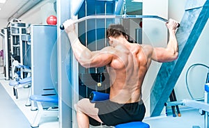 Athletically built sportsman in the gym