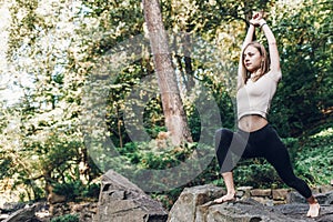 Athleticwoman standing in yoga pose. Yoga exercise outdoor