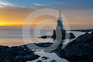 Athopol Lighthouse on the Black Sea coast of Bulgaria with tidal pools in the foreground at sunrise