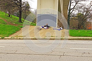 Homeless man camped out under a bridge just outside of downtown Atlanta Georgia