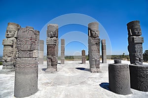 Atlantean figures and ancient pillars against blue sky at the arc