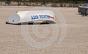 Atlantic City, New Jersey - May 24, 2019: View beautiful white beach sand with Atlantic City rescue boat turned upside down. The