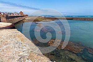 Atlantic coast near defending walls of Portuguese build fortified port city Mazagan, currently El Jadida. Long stone walls