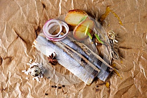 Atlantic herring fillet with potatoes on paper. The view from the top.