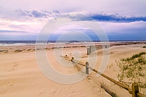 Wooden fence and sandy beach photo