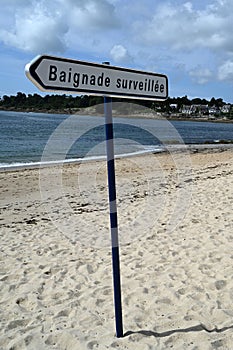 Atlantic Ocean coastline beach in Brittany with a sign