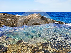 Atlantic Ocean with a natural pool in Caleta de Fuste, Fuerteventura, Spain