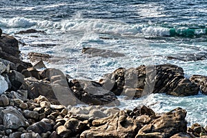 Atlantic Ocean. Pacific ocean waves crashing on rocks foaming in the water