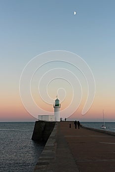 atlantic ocean, pier and lighthouse in la chaume in vendÃ©e (france) photo