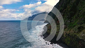 The Atlantic ocean seaside with a waterfall. The seashore waterfall on Madeira.