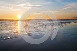 Atlantic ocean sunset with surging waves at Fonte da Telha beach, Portugal