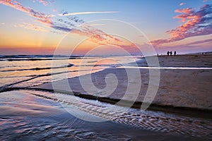 Atlantic ocean sunset with surging waves at Fonte da Telha beach, Portugal photo