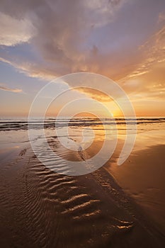 Atlantic ocean sunset with surging waves at Fonte da Telha beach, Portugal photo