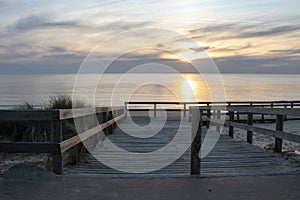 Atlantic ocean sunset in wooden pontoon Lacanau sea beach in gironde France