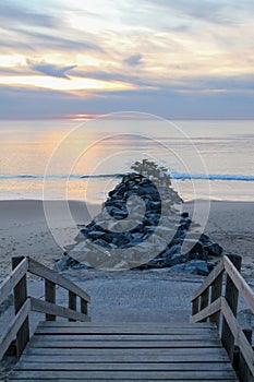 Atlantic ocean sunset in wooden pontoon Lacanau sea  stone access beach in medoc gironde France