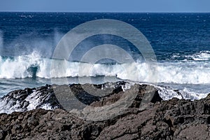 Atlantic ocean waves crashing over volcanic lava rocks on La Palma Island, Canary Islands, Spain
