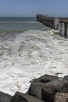 Atlantic ocean waves dashing at historical pier, Swakopmund, Namibia