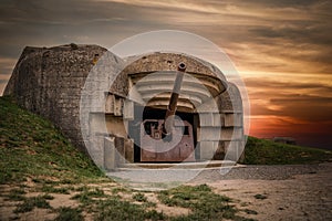 Atlantic wall concrete German World War Two gun emplacement fortification bunker battery Longues-sur-mer in Normandy Gold Beach