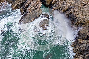 Atlantic waves splash against the rock at the Donegal coast in Ireland