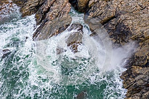 Atlantic waves splash against the rock at the Donegal coast in Ireland