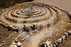 Atlantis spiral sign in Ibiza with stones on soil photo