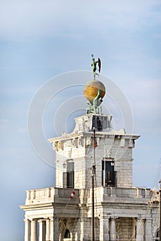 Atlas statues dogana di mare customs house at grand canal in venice italy. 17th century atlases hold globe with weathervane on top