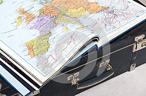 Atlas of the world on a suitcase