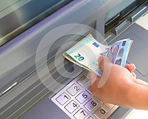 atm and banknotes in euros and the hand