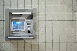 ATM machine. Automated teller bank cash machine on concrete wall