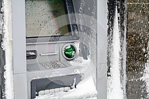 Atm machine covered with snow. Functional bank atm machine cover