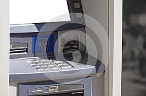 ATM machine frontal shot, keypad / pinpad and card insertion mechanism visible. Front of a modern atm, nobody