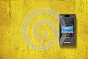 ATM machine on textured yellow wall background