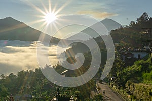 The atmosphere of Mount Batur in the morning where the caldera is covered by low stratus clouds. The sky looks bright blue and