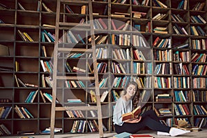 An atmosphere of passionate story reading. reading books lovely young woman. Library cozy room.