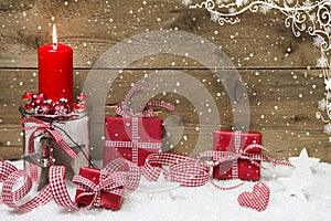 Atmospheric Christmas card with red burning candle and presents