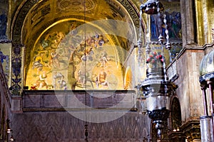 Foreground of incense burner and Tree of Jesse mosaic inside St. Mark`s Balsica in Venice.
