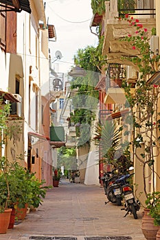 An atmospheric narrow Greek street between tenement houses