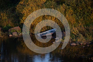 Atmospheric photograph of abandoned boats on the river bank