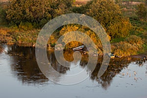 Atmospheric photograph of abandoned boats on the river bank