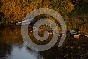 Atmospheric photograph of abandoned boats on the river bank