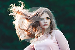 Atmospheric portrait of young beautiful woman, long hair and casual makeup