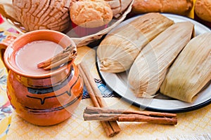Atole de chocolate, mexican traditional beverage and tamales, Made with cinnamon and chocolate in Mexico photo