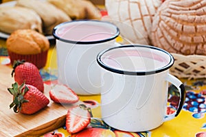 Atole de fresa, mexican traditional beverage and bread, Made with cinnamon and strawberries in Mexico photo