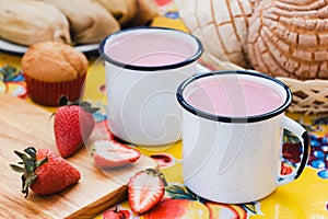 Atole de fresa, mexican traditional beverage and bread, Made with cinnamon and strawberries in Mexico