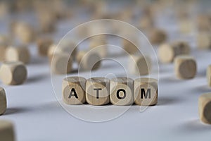 Atom - cube with letters, sign with wooden cubes